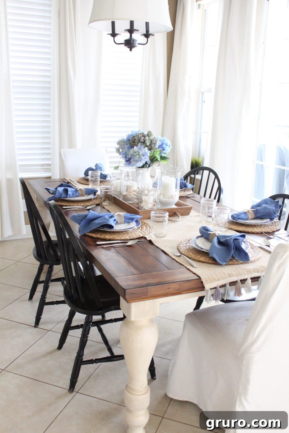 Monday Summer DIY Inspiration 5 A beautifully set blue and white kitchen table, evoking a fresh and serene coastal summer ambiance.