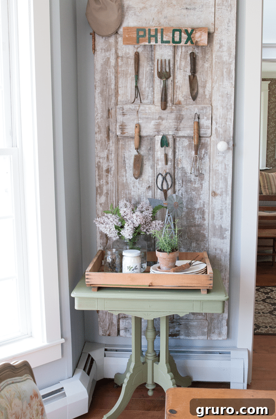 Monday Summer DIY Inspiration 7 A creative vintage garden tool gallery wall made with an old door, offering unique rustic decor for outdoor spaces.