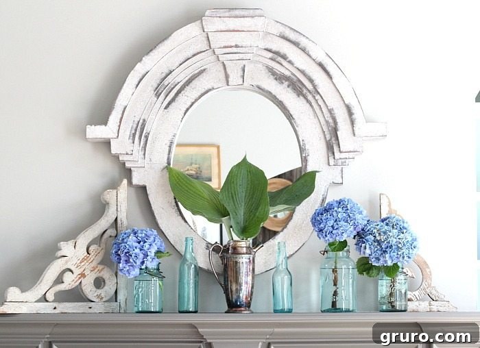 Aqua mason jars and vintage soda bottles elegantly arranged on a mantel, holding fresh hydrangeas