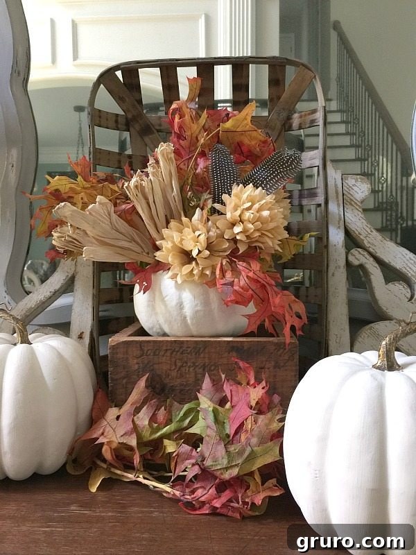 DIY Fall Pumpkin Centerpiece: Mums, Leaves, and Feathers Close-up of a DIY fall pumpkin centerpiece featuring white paint, vibrant mums, and delicate feathers