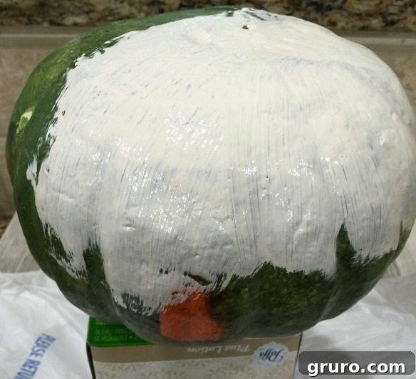 Instant Thrift Store Pumpkin Glow-Up 3 Faux pumpkin in the process of being painted with craft paint for a fall decor update