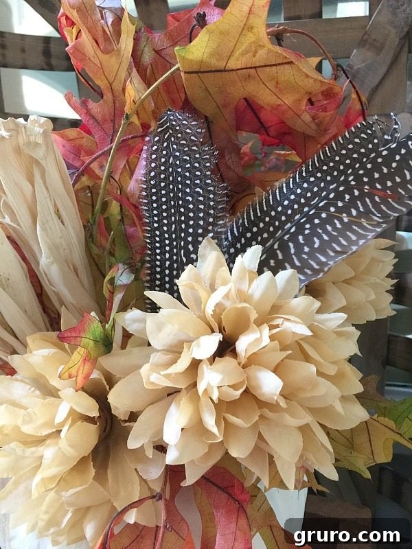 Adding Feathers: The Crowning Touch to Fall Decor Close-up of elegant feathers integrated into a fall pumpkin decor arrangement