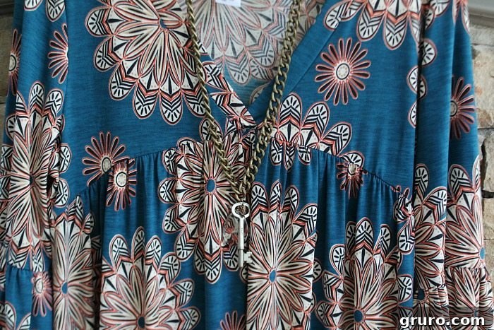 Close-up details of The Bryce Tunic from Glamour Farms, showcasing the floral pattern and fabric texture.
