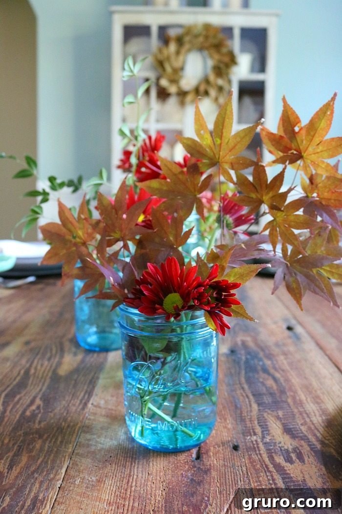 Vintage Blue Jar Table Accent 11 Inspiring image showing how to fill blue mason jars with leaves from the yard for a pretty, natural centerpiece