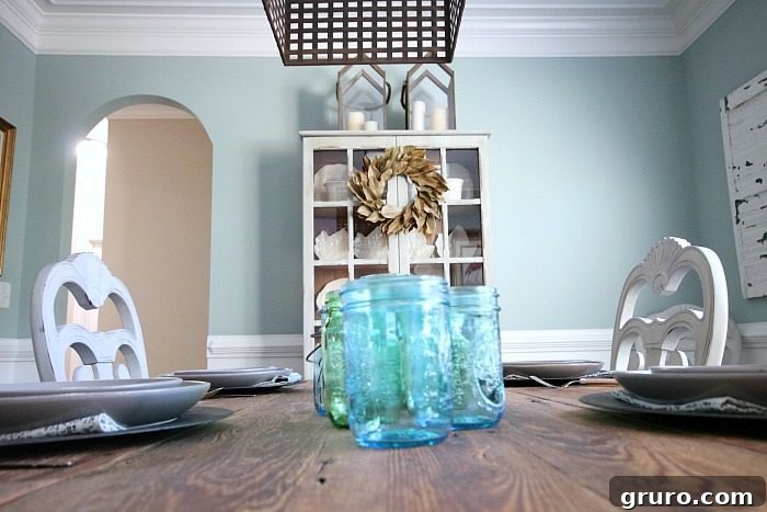 Vintage Blue Jar Table Accent 3 Cozy barnwood dining table set with a painted pine hutch in the background, ready for fall entertaining