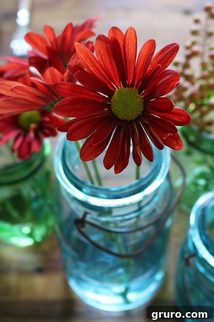 Vintage Blue Jar Table Accent 4 Close-up of blue mason jars showcasing the rich, vibrant colors of fall flowers and leaves