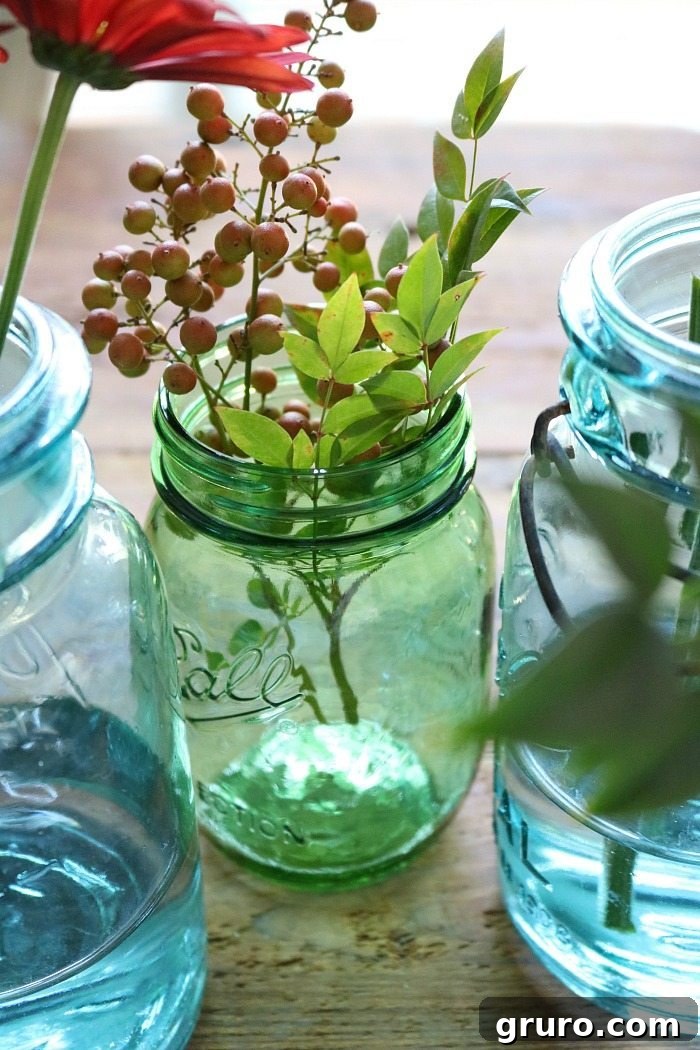 Vintage Blue Jar Table Accent 7 An array of blue and green mason jars artfully arranged and filled with diverse fall foliage
