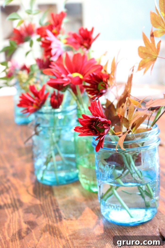 Vintage Blue Jar Table Accent 9 Beautiful blue mason jars adorned with rich maple leaves and classic fall mums