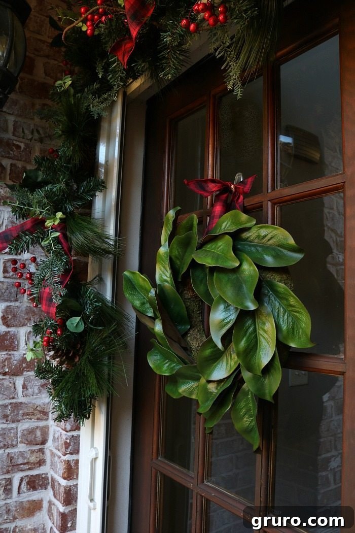 Elegant Magnolia Wreaths for a Rustic Christmas Porch magnolia-wreath-with-plaid-ribbon-for-the-front-door-at-christmas