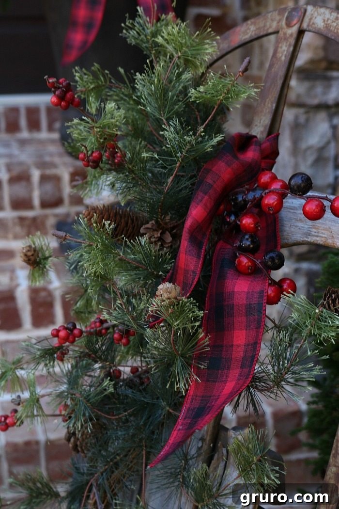 Plaid Ribbon and Greenery on an Old Sled - Rustic Christmas Porch plaid-and-greenery-dress-up-an-old-sled-for-rustic-farmhouse-front-porch