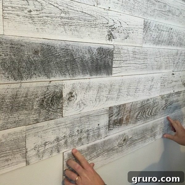 10 Timeless Farmhouse Decor Ideas 3 Installing Stikwood for a weather white farmhouse wall treatment at Refresh Restyle, creating rustic elegance