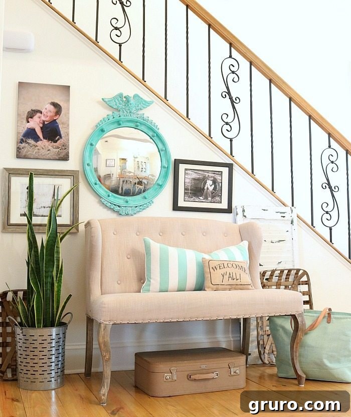 Close-up of the entryway decor, showcasing a 'Welcome Y'all' pillow and other turquoise accents harmonizing beautifully with the thrifty mirror.