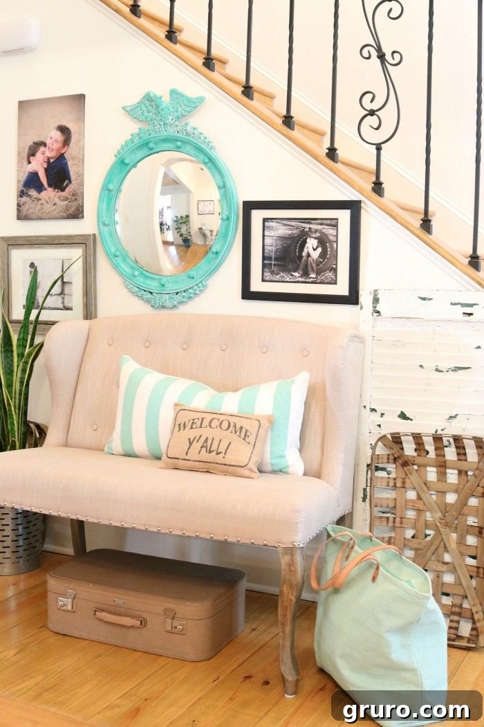 Detailed view of the turquoise mirror in the entry, highlighting the successful thrift store makeover with paint and wax, showcasing its federal style.