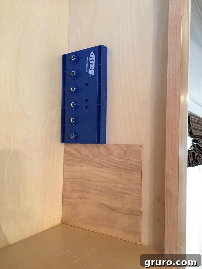 Smart Mudroom Storage 5 A custom wood jig being used to position the Kreg shelf pin jig for precise shelf hole drilling