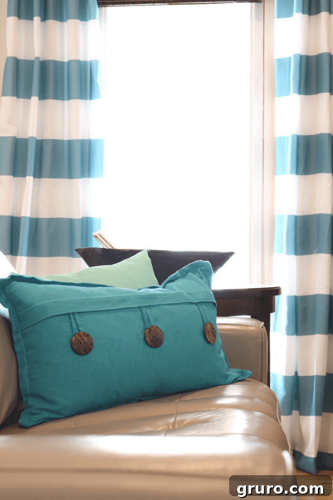 A beautiful blend of aqua, turquoise, and other blue tones creates a calming and cohesive look in the living room.