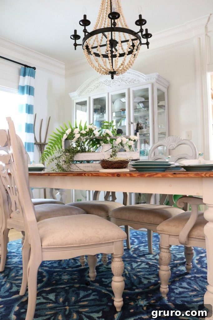 Elegant beaded chandelier illuminating a farmhouse dining room, perfectly complementing the spring tablescape.