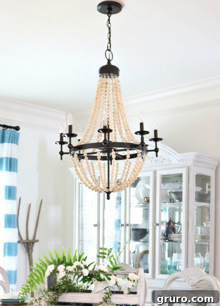 A newly installed beaded chandelier provides a touch of rustic elegance to the farmhouse dining room.