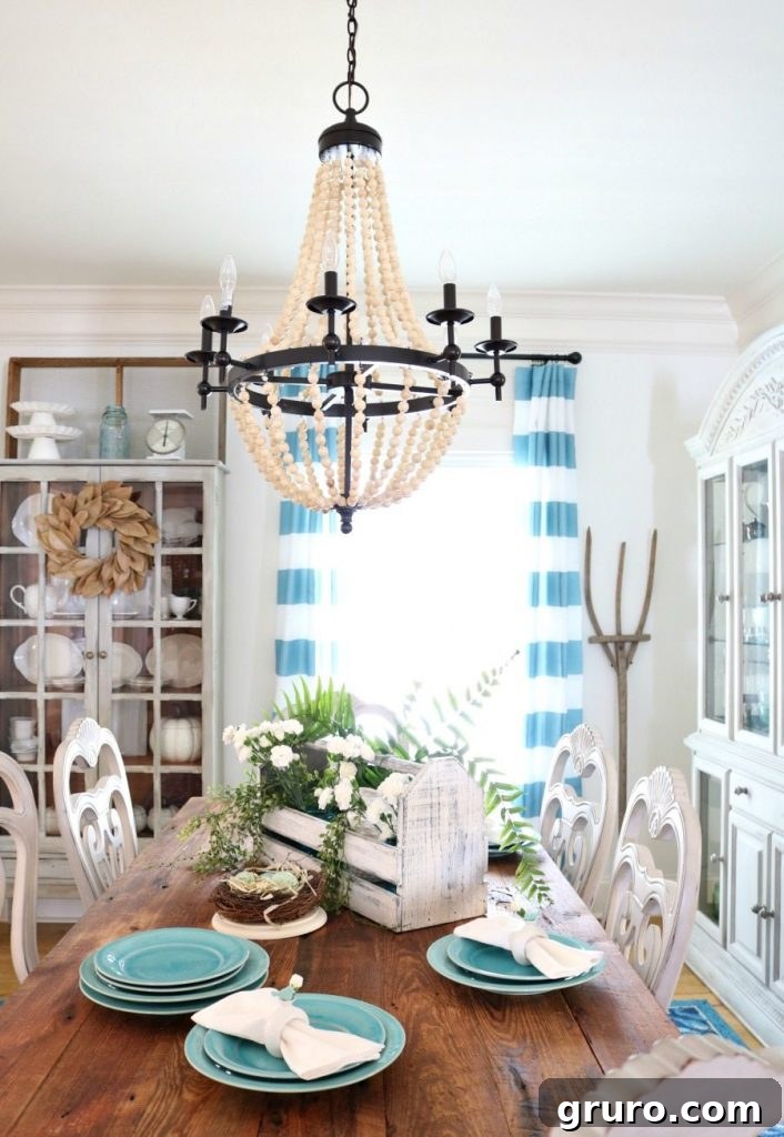 A beautifully set spring tablescape in a farmhouse dining room, featuring fresh colors and natural elements.