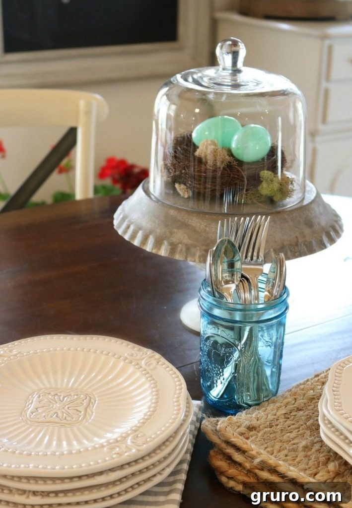 Plastic eggs beautifully displayed under a glass cloche, elevating simple spring decor with elegance.