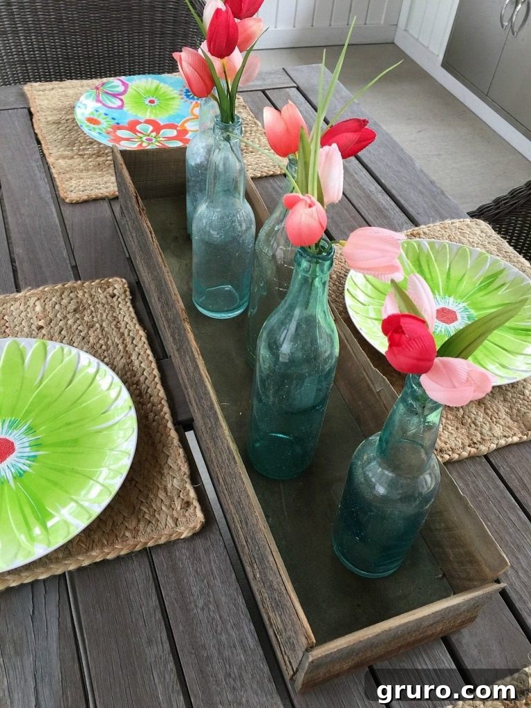 A charming farmhouse dining table adorned with antique blue bottles, adding a touch of vintage elegance to the porch.