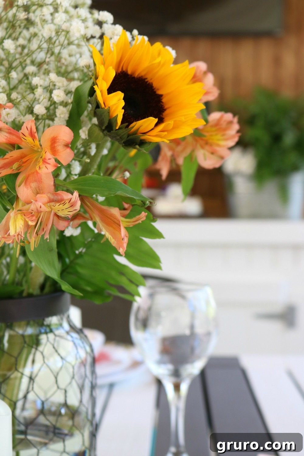 Streamlined Style, Supreme Outdoor Comfort 2 Grocery store flowers in Better Homes and Gardens chicken wire candle holder, enhancing outdoor dining appeal.