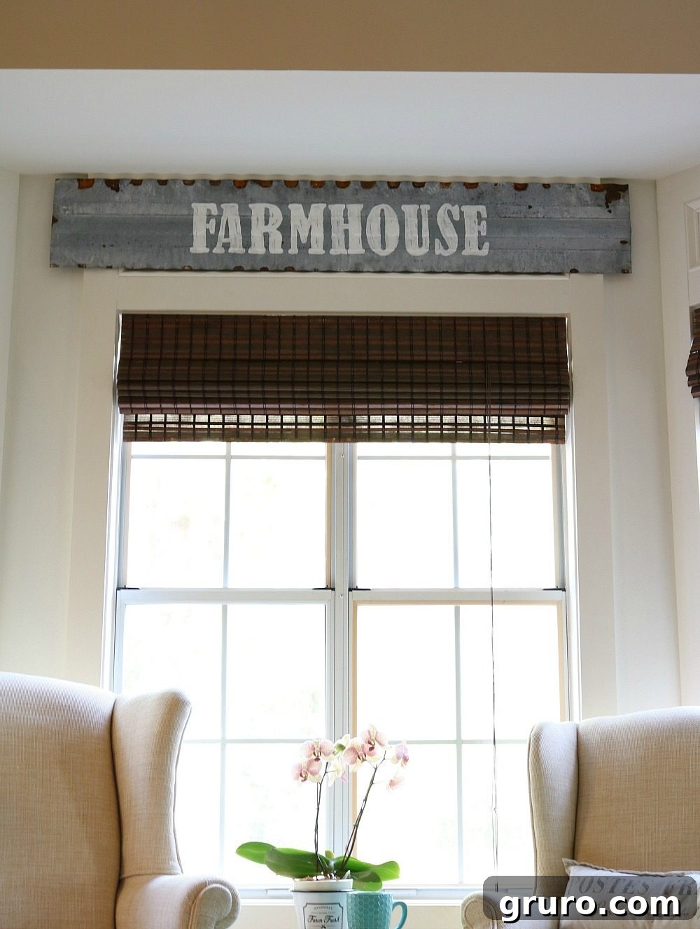 Repurposed chicken coop top transformed into a metal farmhouse sign