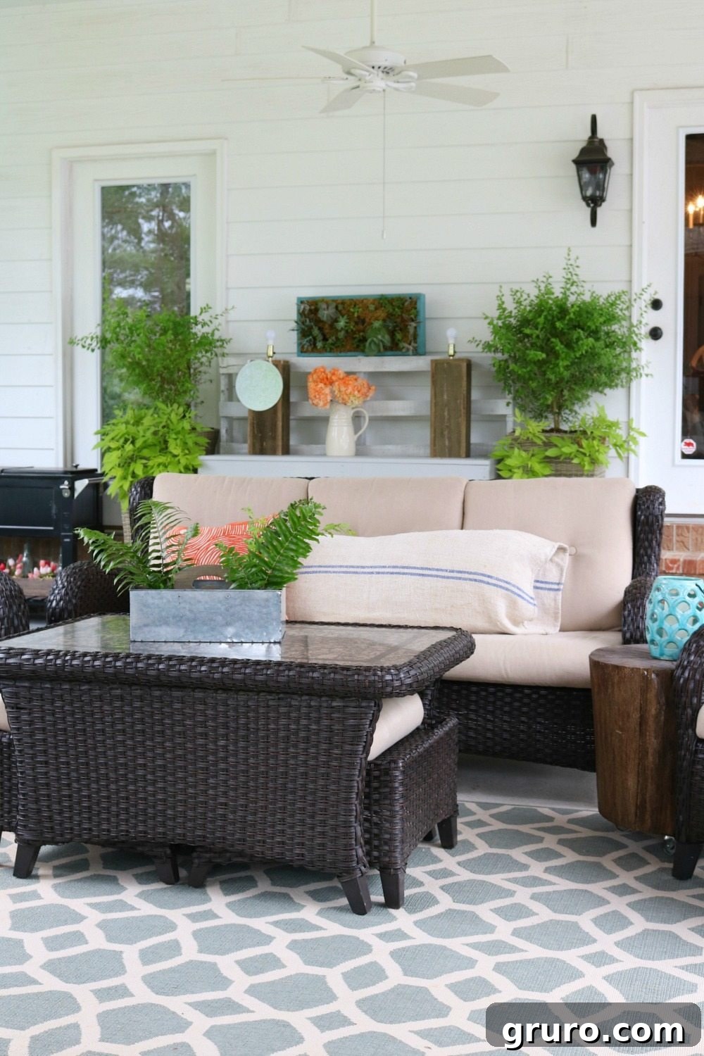Grain sack pillow on an outdoor sofa, a perfect farmhouse addition to the porch