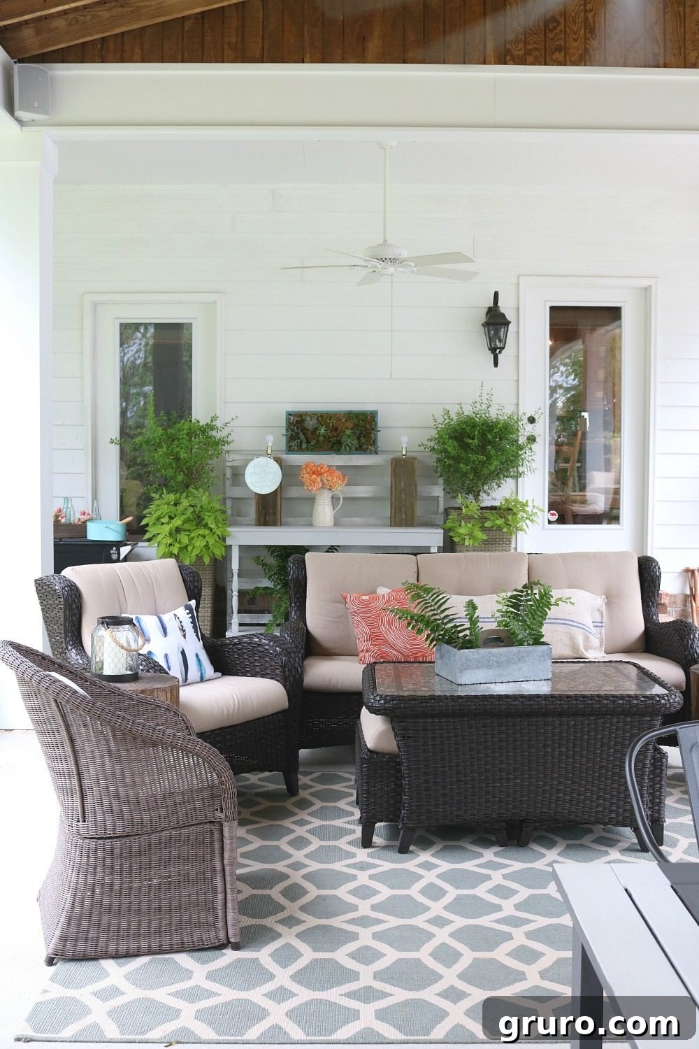 Inviting living area on a summer-ready farmhouse porch, designed for comfort and entertaining