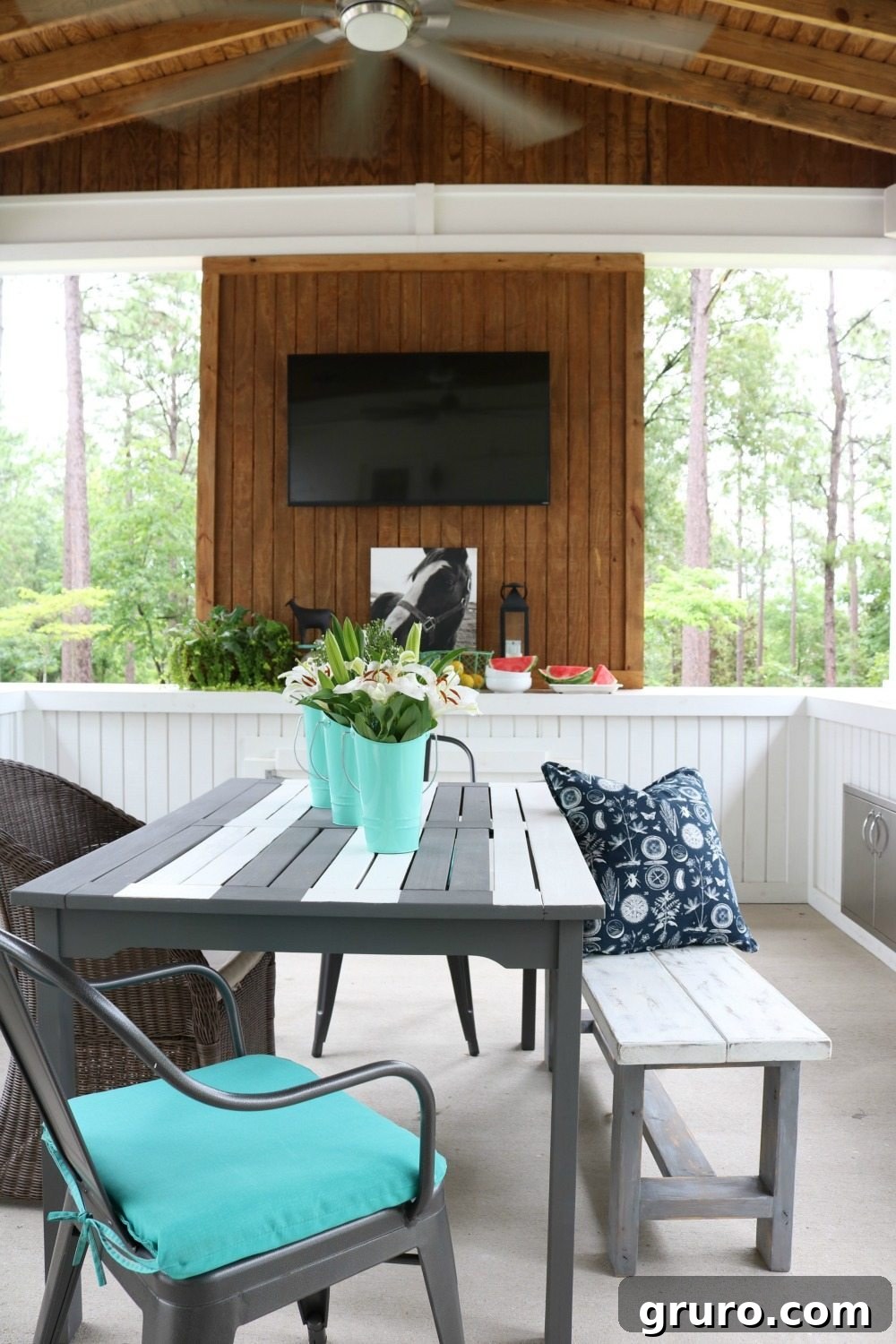 Outdoor TV wall area with decorative elements on a farmhouse porch
