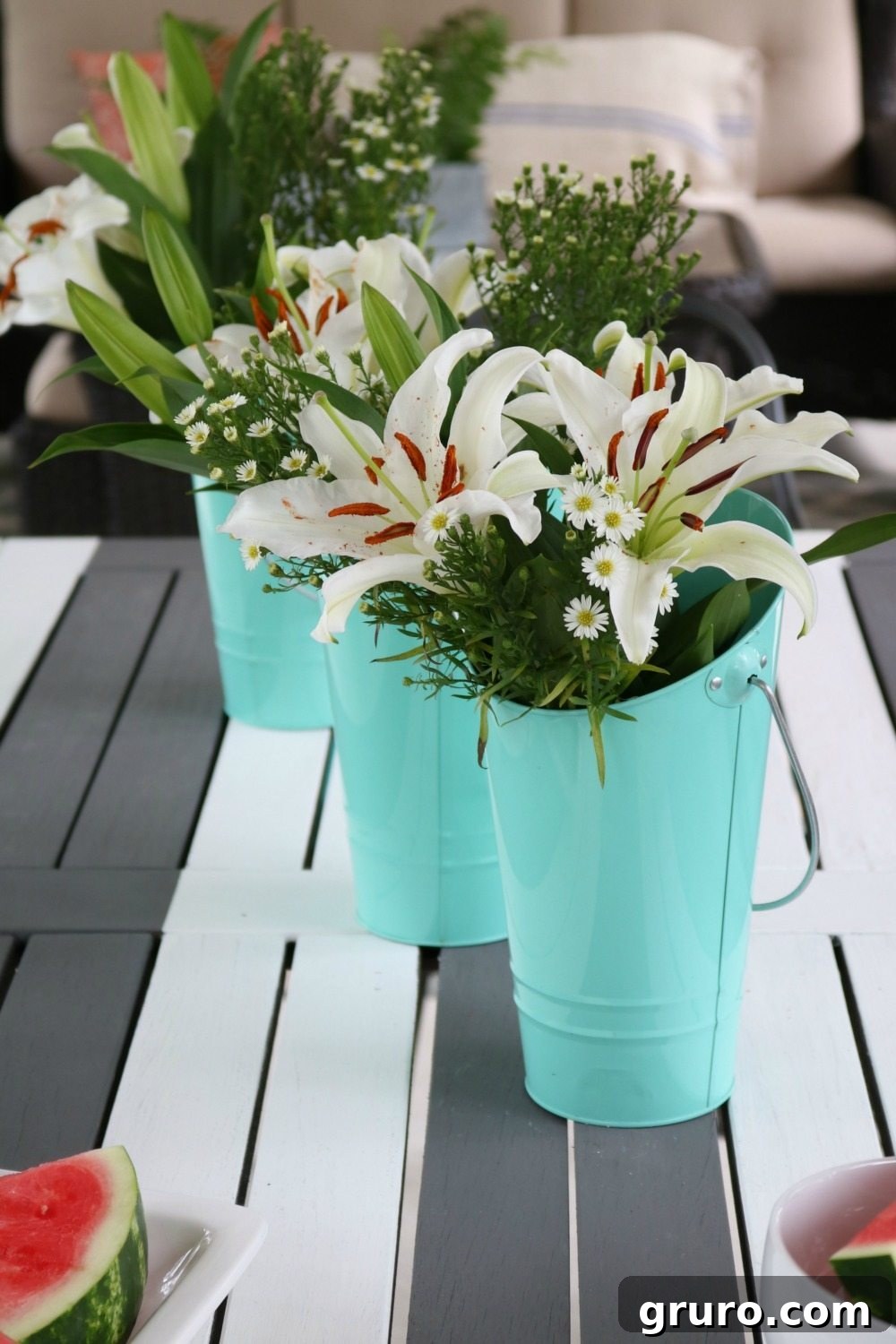 Target Dollar Spot buckets used as charming flower vases on a farmhouse porch