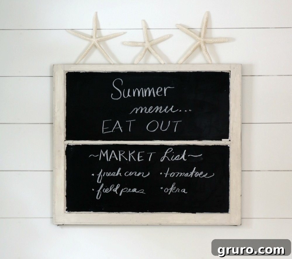A decorative starfish gracefully resting on an old window chalkboard, creating a subtle yet effective summer accent in a farmhouse kitchen.