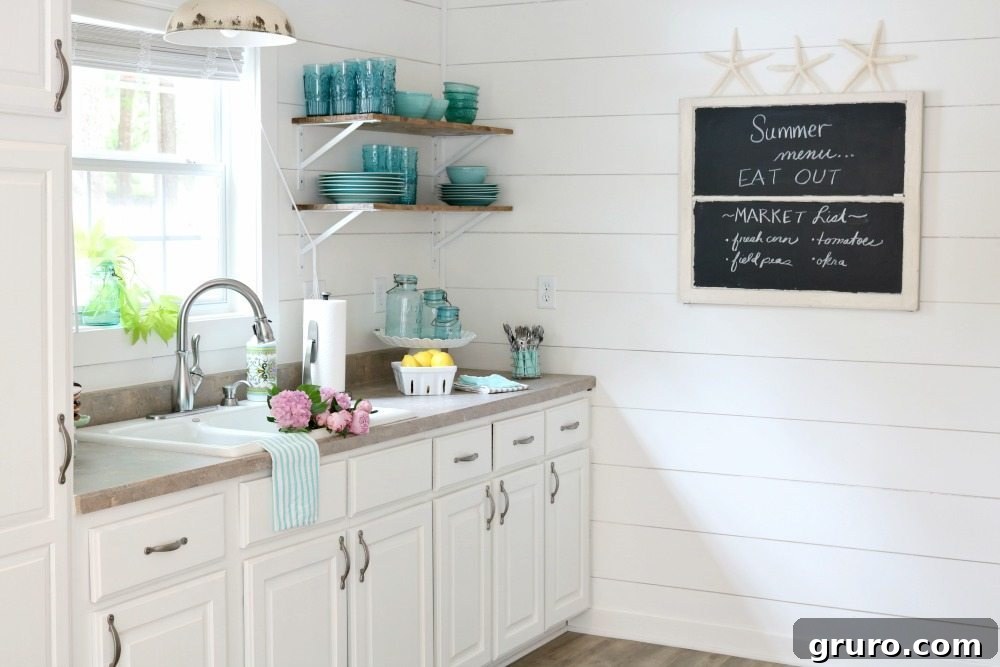 Small farmhouse cottage kitchen with bright white walls, open shelving, and minimalist decor, emphasizing efficient use of space.