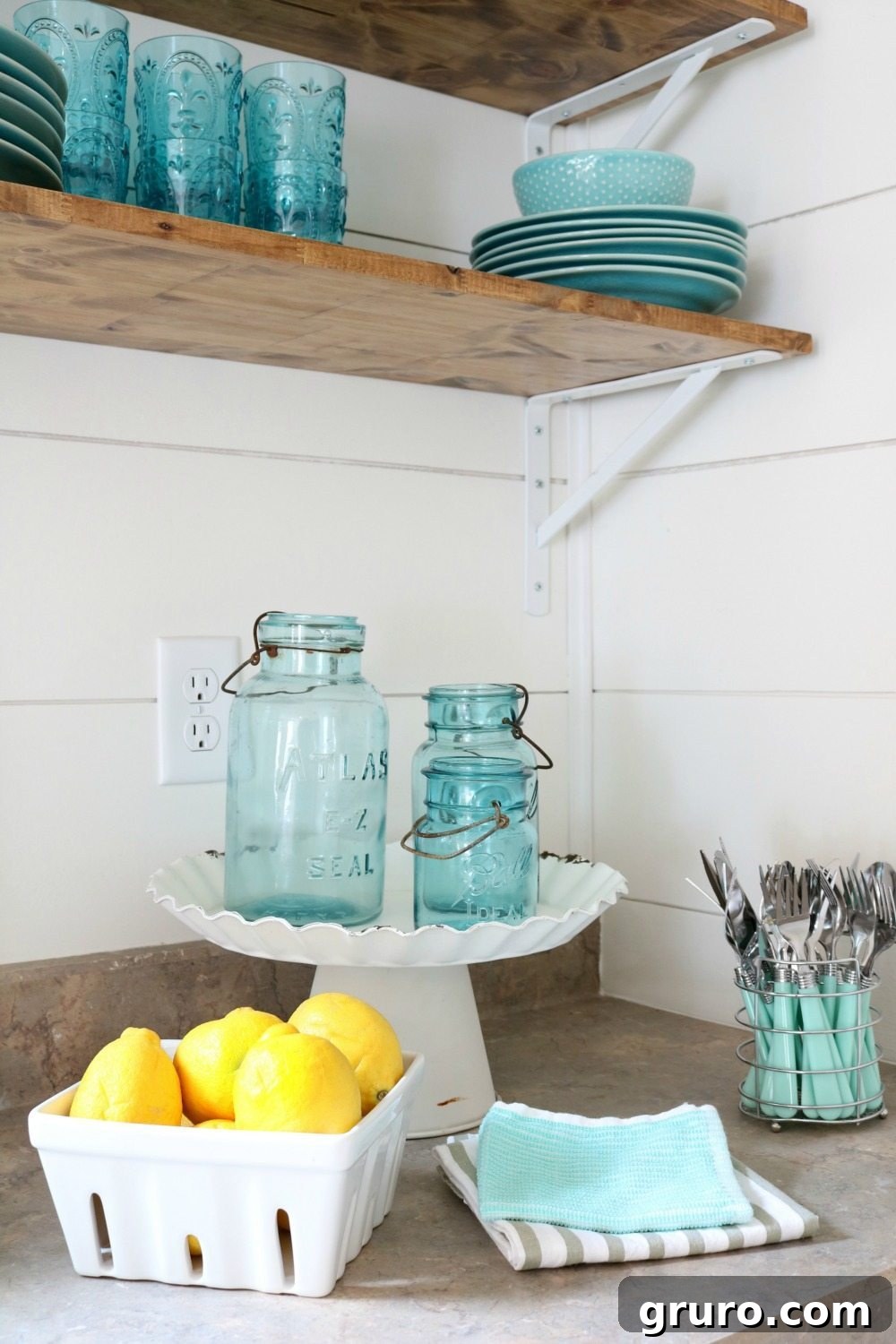 Fresh yellow lemons artfully arranged in a rustic berry basket, serving as a bright and cheerful decor idea for a farmhouse cottage kitchen.