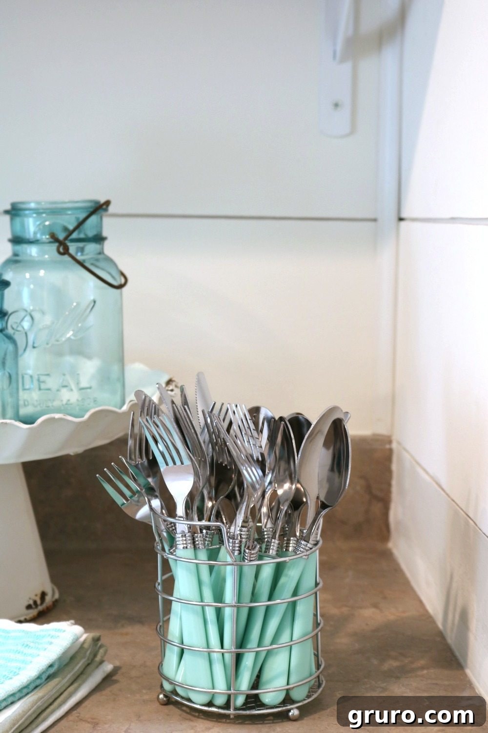 A charming set of turquoise aqua silverware from Hobby Lobby, adding a perfect pop of summer color to the farmhouse cottage kitchen.