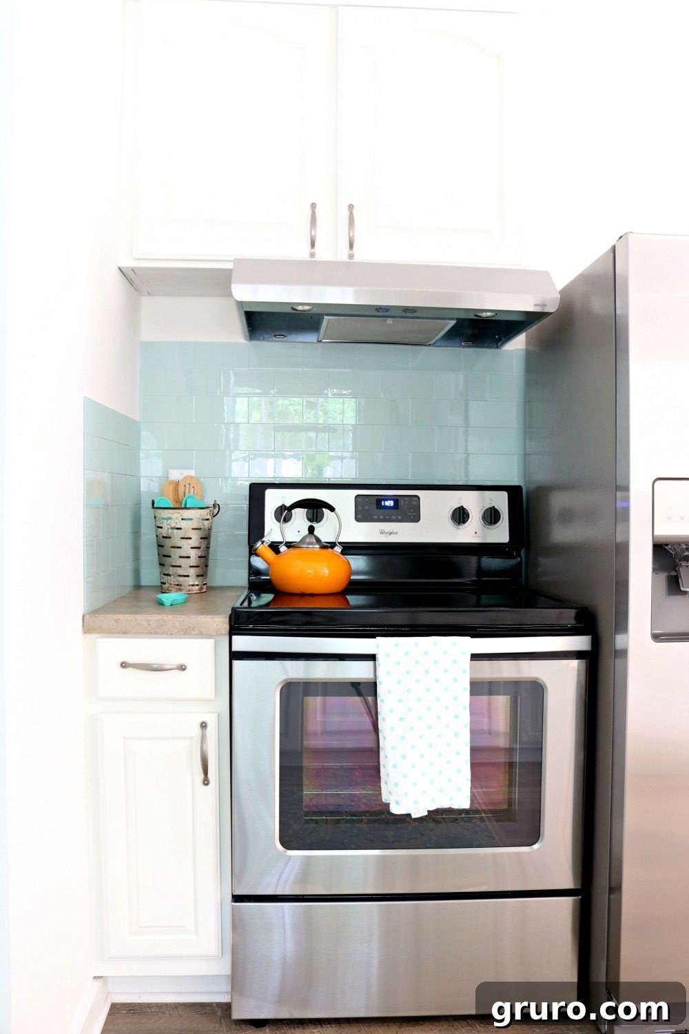 Beautiful Aspect stick-on glass tiles in 'Morning Dew' color, forming a stylish backsplash in the tiny farmhouse cottage kitchen.