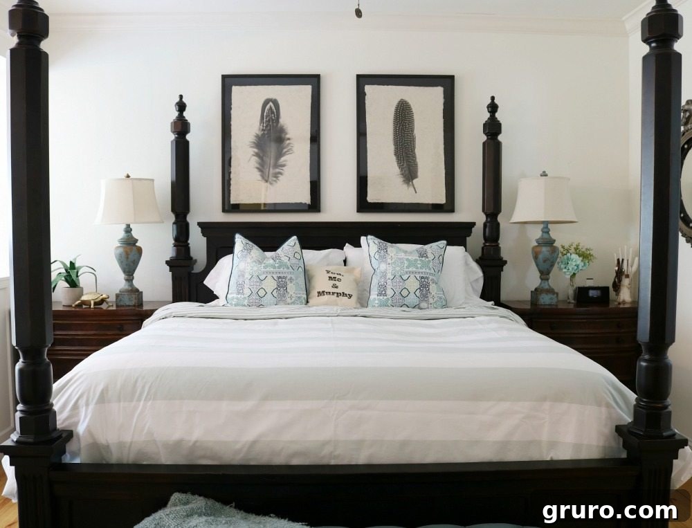 Four poster black bed with blue and white bedding