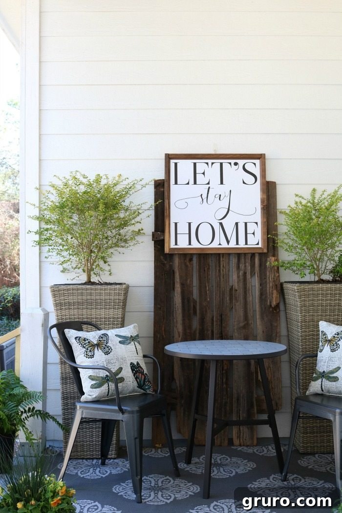 Shiplap-barn-wood-metal-chairs-make-a-great-conversation-area-on-the-porch-at-the-Alabama-Farmhouse-1