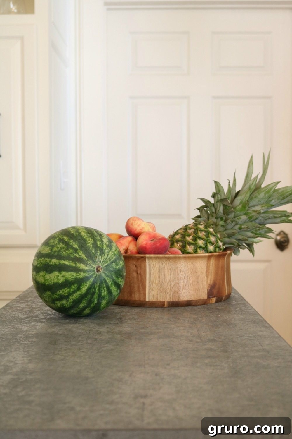 Kitchen island with concrete look top, featuring an acacia bowl, perfect for the kitchen or anywhere