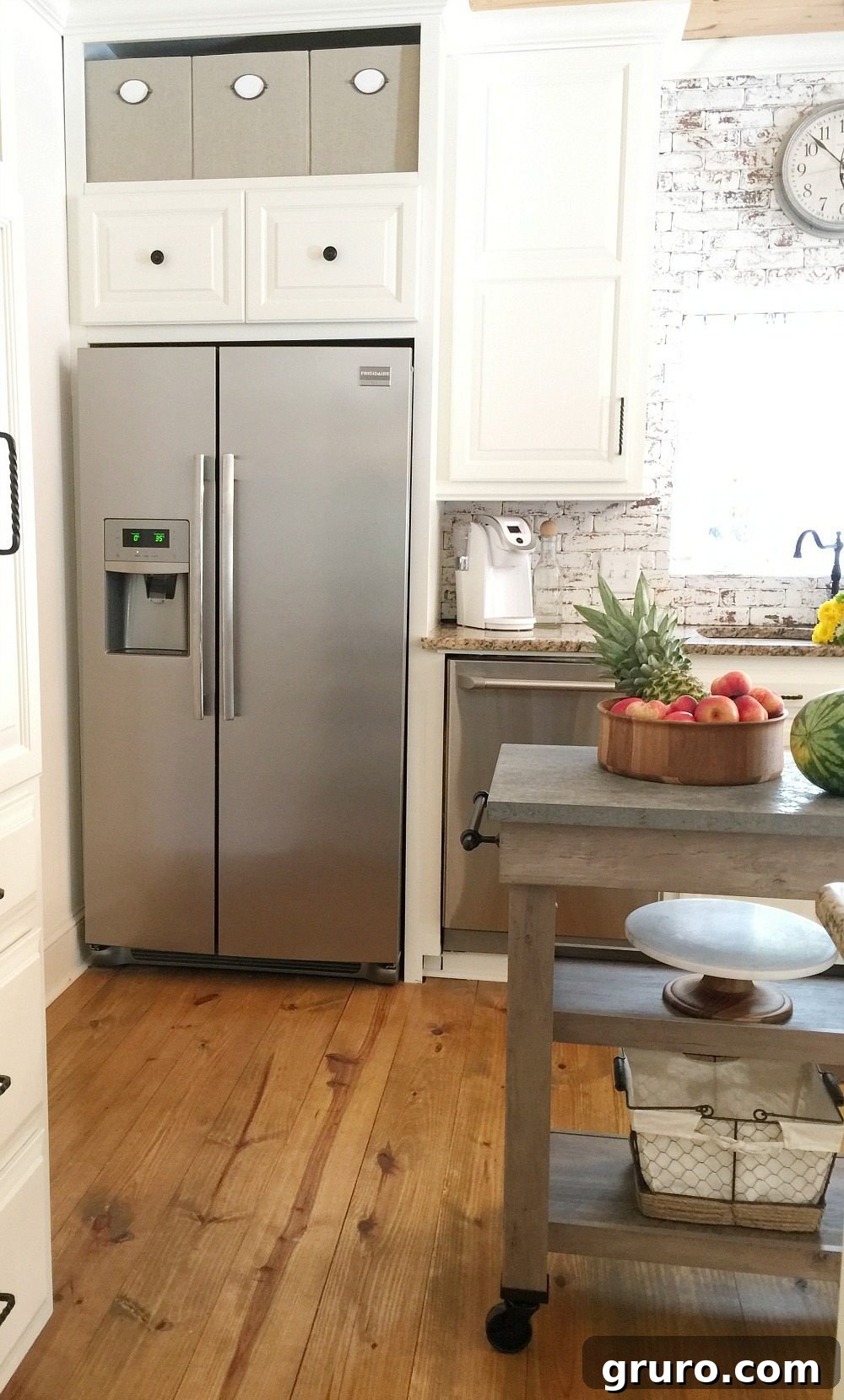 Collapsible fabric storage cubes above the refrigerator for organized kitchen storage