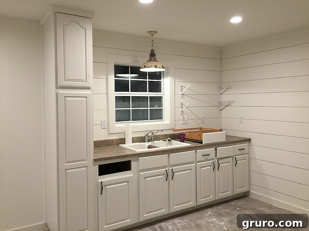 Late night painting session in the farmhouse cottage kitchen to complete the renovation.