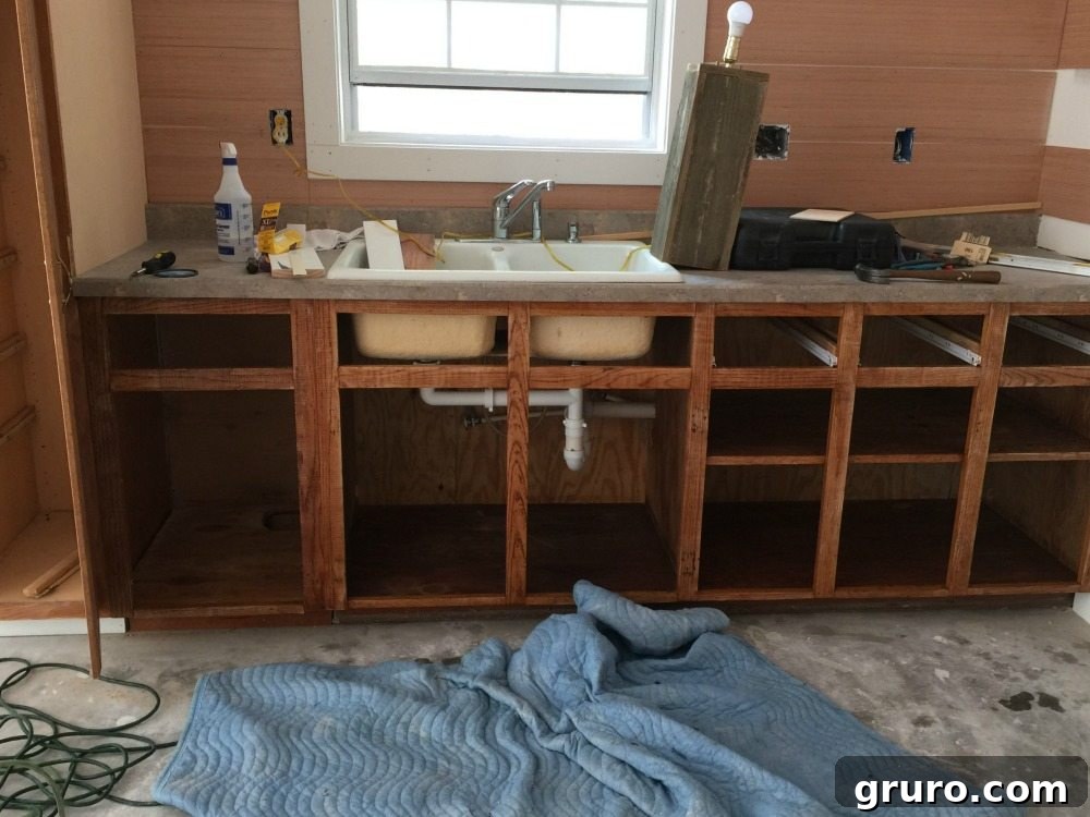 Cottage kitchen base cabinets after thorough cleaning and priming, ready for painting.