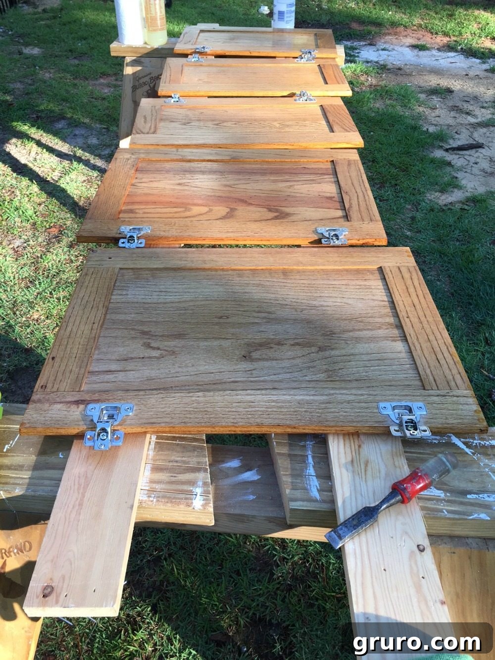 Removing cabinet doors and hardware as the first step in the painting process.