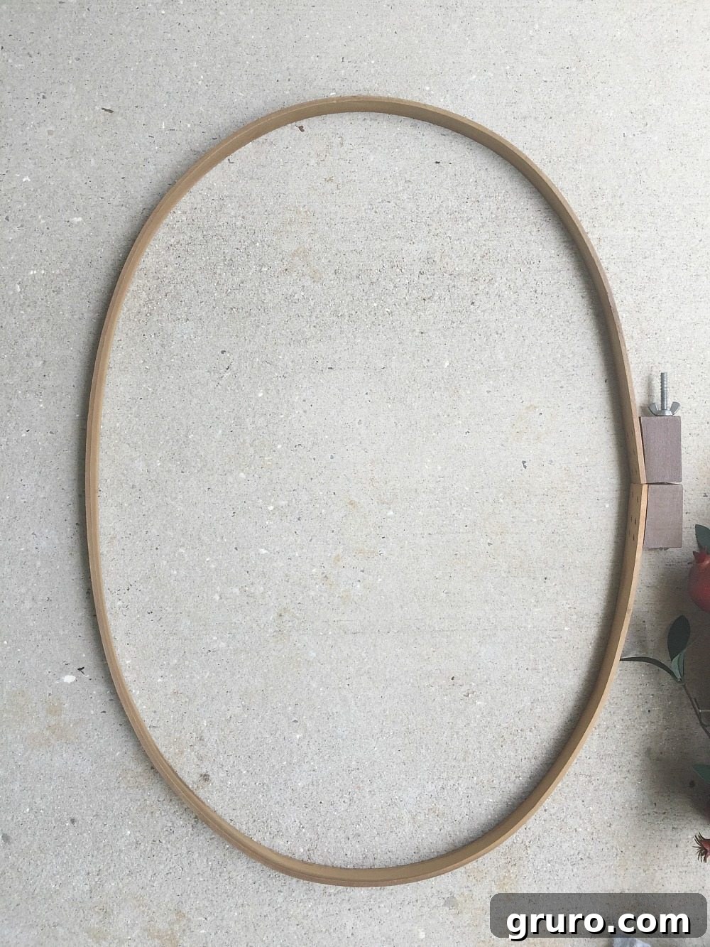 The oval quilt hoop found at Goodwill, showcasing its unique shape and potential for a DIY wreath