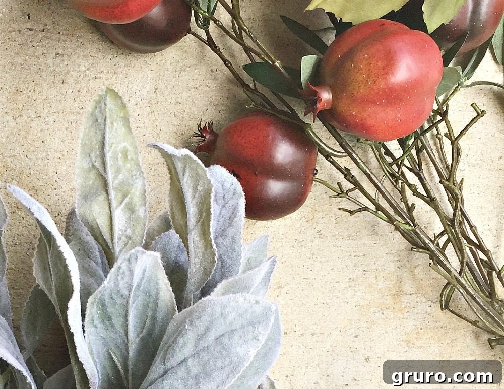 A two-ingredient idea for a fall wreath: an oval quilt hoop combined with faux lambs ear and pomegranates