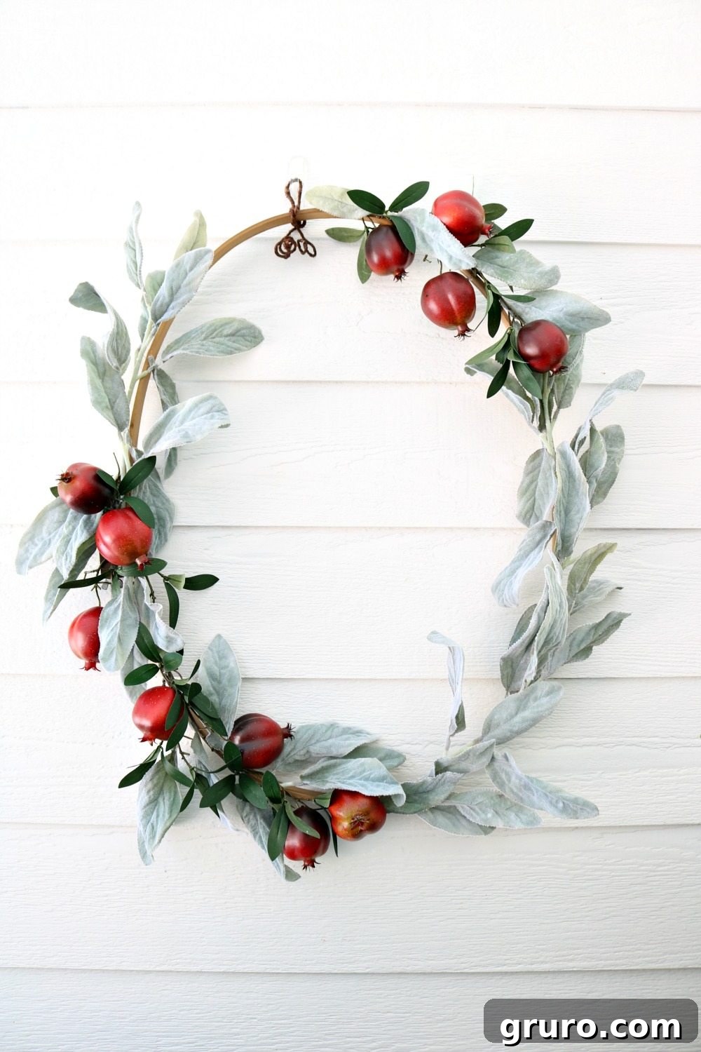 Full view of the fall wreath made from an oval quilt hoop, showcasing its graceful design at Refresh Restyle