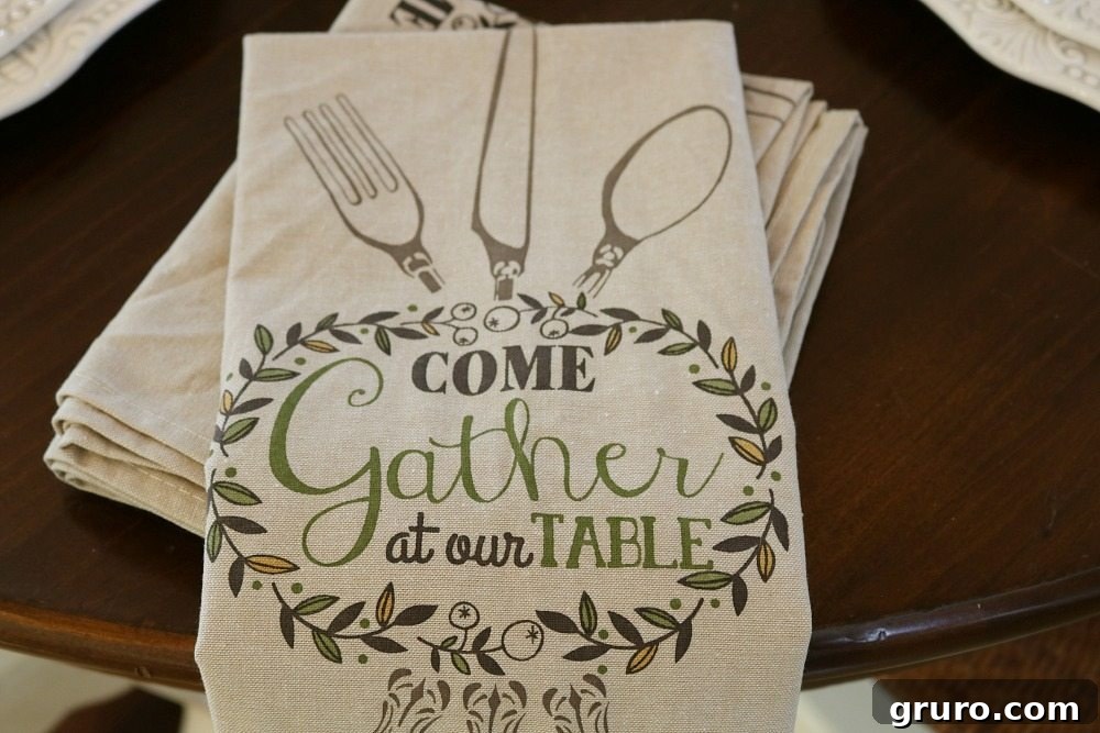 Close-up of dish towels used as elegant napkins on a fall-themed dining table.