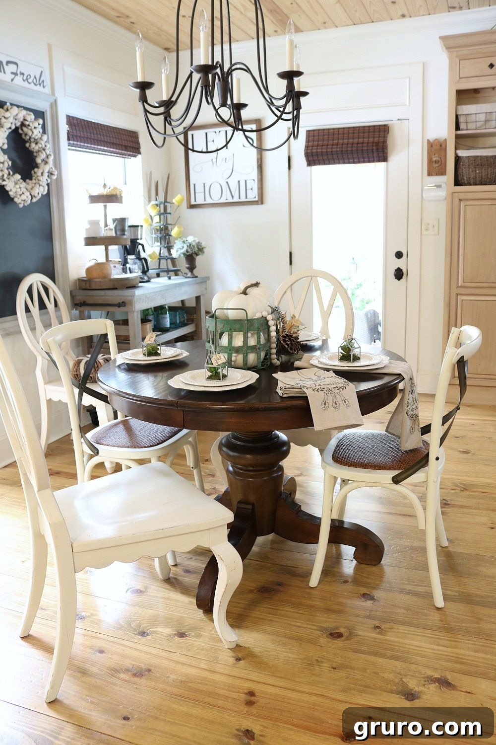Pine floors and ceiling in the breakfast area of Refresh Restyle's farmhouse kitchen, with fall decor.