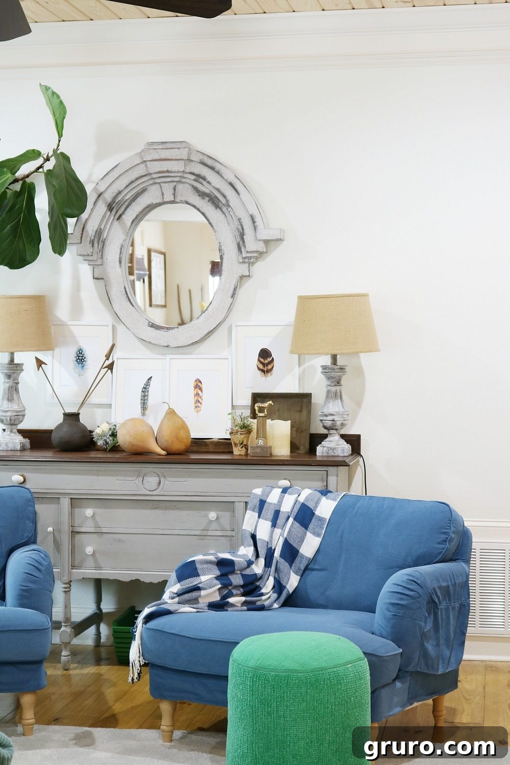 Living room decorated for fall with feather art, touches of blue, and green accents creating a cozy space.