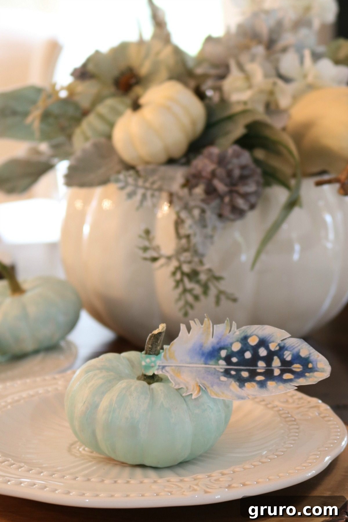 Elegant Plume Place Cards 2 Rustic blue pumpkins with delicate paper feather place cards on a fall table setting