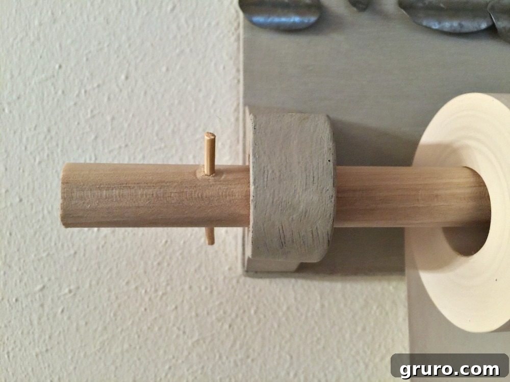 Upcycled Quilt Rack Wall Paper Dispenser 7 Close-up of skewers inserted into the dowel ends to keep the paper roll in place